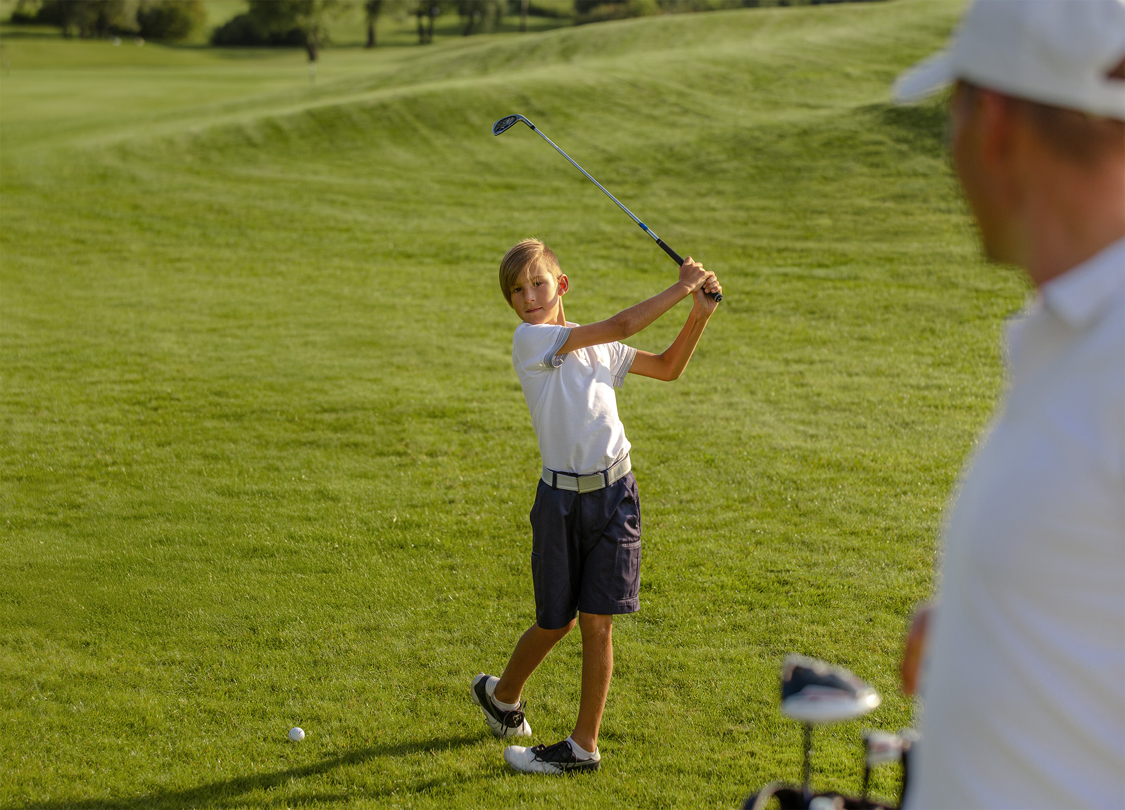 11,years,old,boy,playing,golf,with,his,father,or
